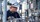 A worker wearing safety gear is inspecting industrial equipment at a plant.