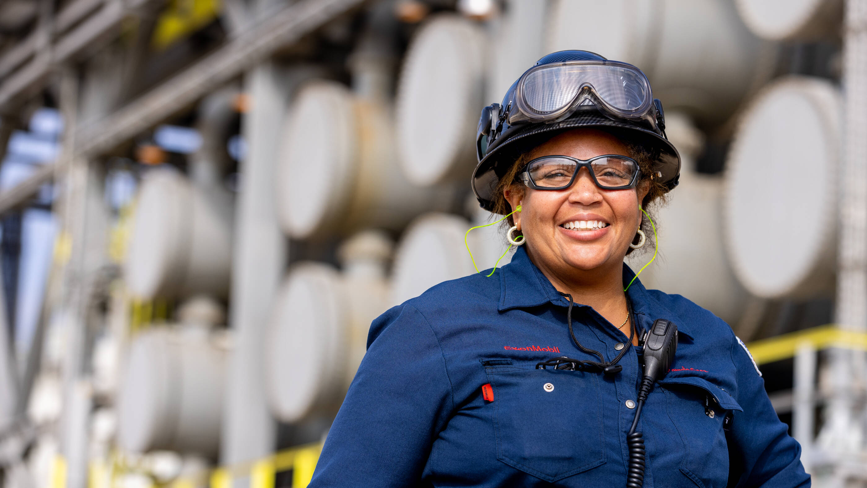 Female employee wearing safety goggles and hard hat