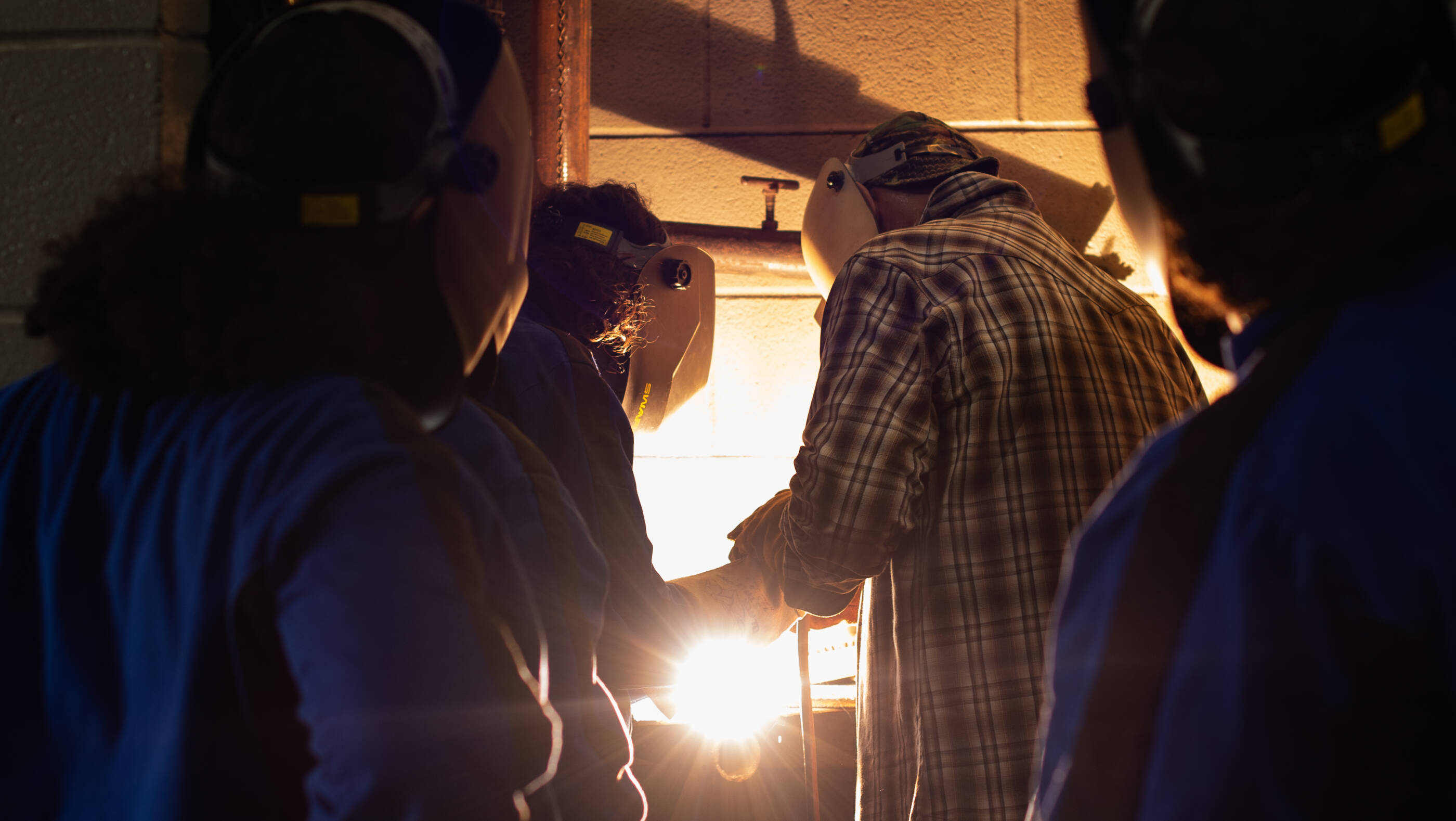 Girls learning to weld at GCGV's girls summer leadership camp